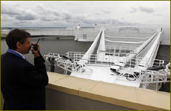 An employee gives instructions to operate a hydro breachblock during a media tour